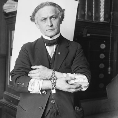 Original Caption: 2/27/1918-Houdini showing how to slip handcuffs.