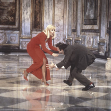 Italian actor and director Roberto Benigni trying to grab Italian showgirl Raffaella Carrà (Raffaella Maria Roberta Pelloni)'s legs during a sketch in Fantastico 12. Rome, 1991