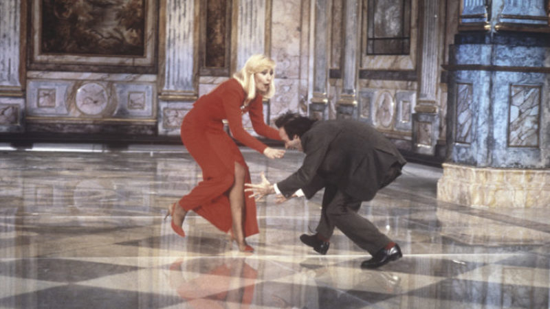 Italian actor and director Roberto Benigni trying to grab Italian showgirl Raffaella Carrà (Raffaella Maria Roberta Pelloni)'s legs during a sketch in Fantastico 12. Rome, 1991