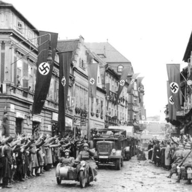 Einmarsch in das Sudetenland. Motorisierte deutsche Truppen in Saaz. German mechanized troops enter Saaz. The streets are decorated with swastika flags and banners.
9.10.1938
14.30 Uhr.
Saaz. Sudetenland